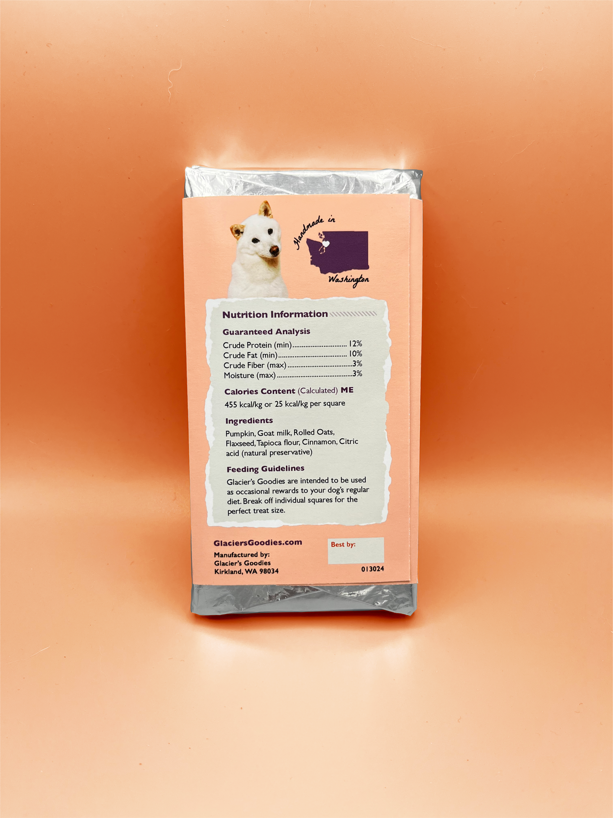 Unpackaged Pumpkin Goat Milk Dog Treat Bar placed on top of a packaged treat bar
