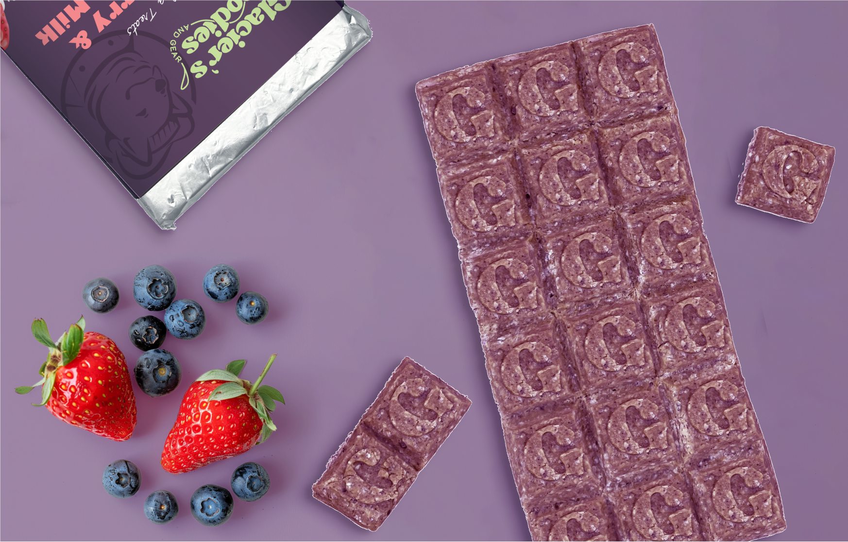 Unwrapped Strawberry and Blueberry Goat Milk Dog Treat Bar laying on top of a wrapped bar